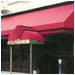 Stylish bump-outs on this bright red awning define the entrances for Savoy Basserie.