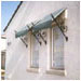 Custom wrought iron spears support these window awnings.