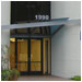 Matching glass awnings with stainless steel frames and cut-out letters at Legacy, San Jose, CA.