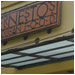 A frosted glass corner awning and ornamental signage at Ernestos Mexican Food, Sacramento, CA.